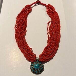 Elegant Orange Beaded Necklace with Turquoise Pendant